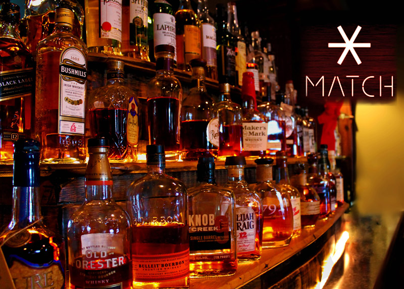 Bourbon shelf with Match Cigar Bar logo, premium spirits selection for family gatherings and celebrations